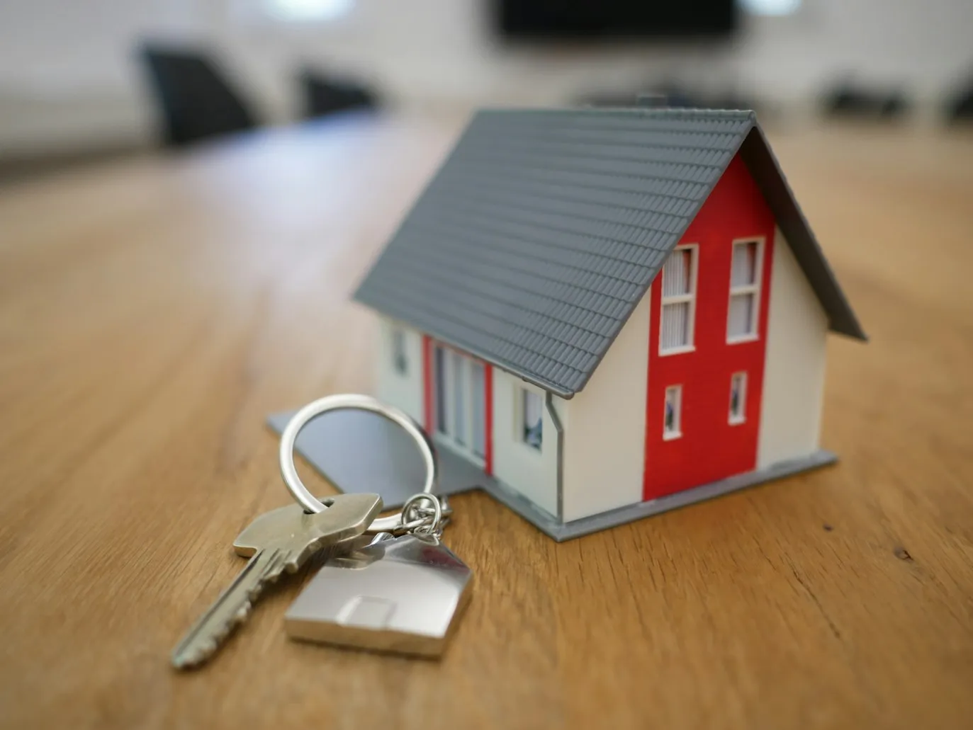 Happy family receiving house keys in front of a new home